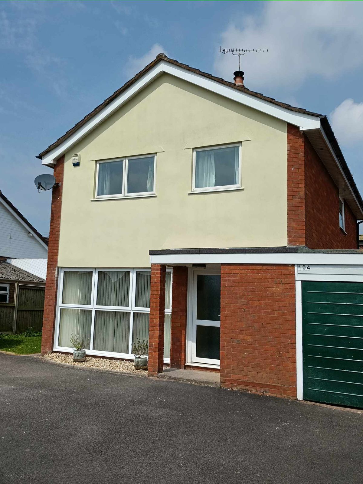 A detached house finished in cream render